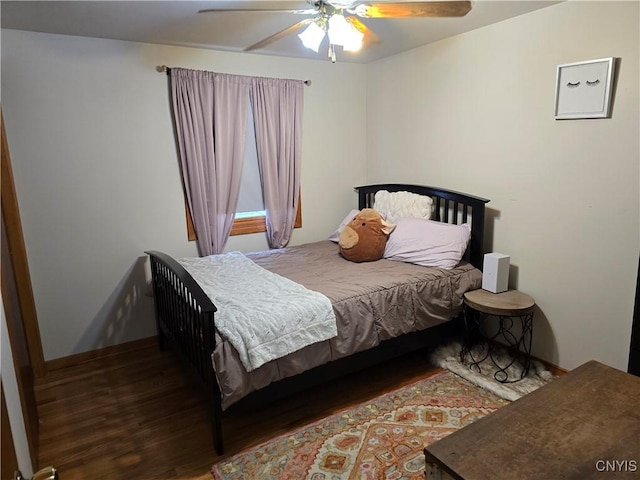 bedroom with ceiling fan and dark hardwood / wood-style floors