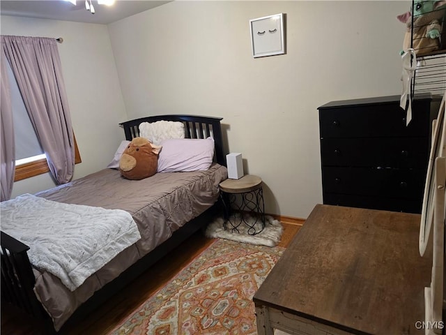 bedroom with dark wood-type flooring