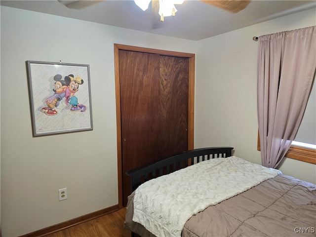 bedroom featuring ceiling fan, a closet, and wood-type flooring