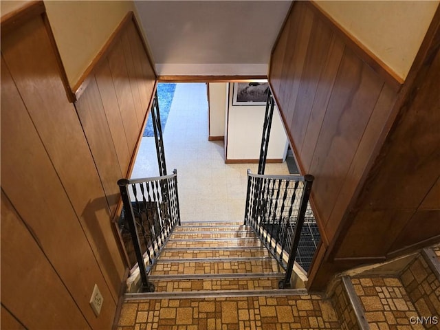 stairs featuring wooden walls