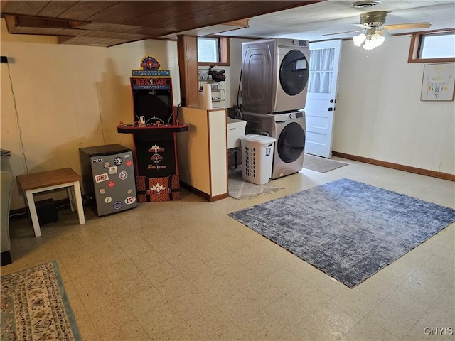 laundry area featuring ceiling fan and stacked washer / drying machine