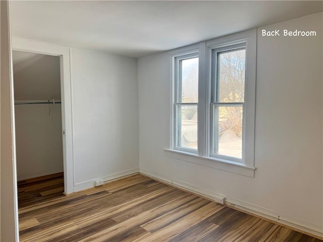 spare room with wood-type flooring