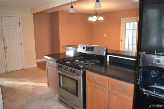 kitchen with stainless steel gas range, a chandelier, and pendant lighting