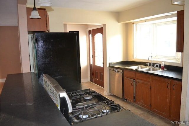 kitchen with sink, hanging light fixtures, and stainless steel appliances