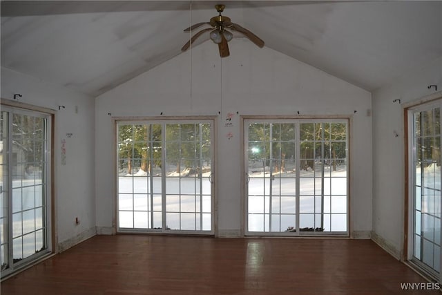 interior space with ceiling fan, lofted ceiling, and dark hardwood / wood-style floors