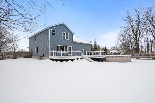 snow covered property featuring a swimming pool side deck