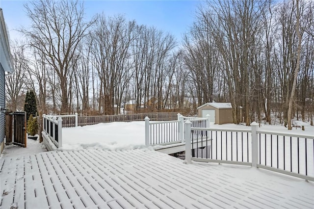 snow covered deck featuring a storage unit