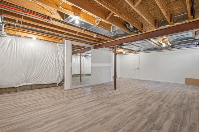 basement featuring hardwood / wood-style floors