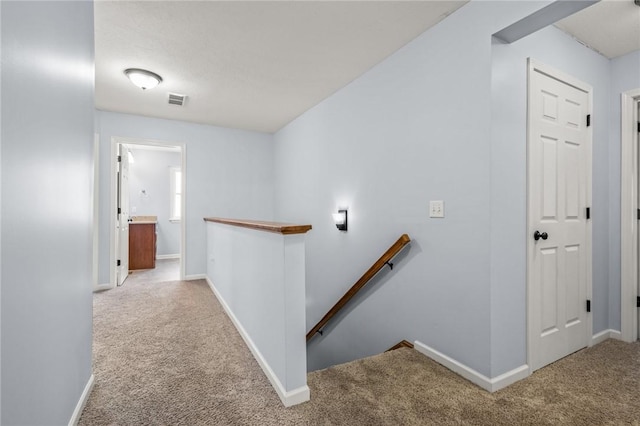 hallway with carpet floors