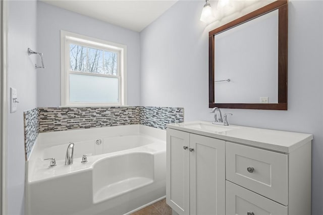 bathroom featuring tile patterned flooring, a washtub, and vanity