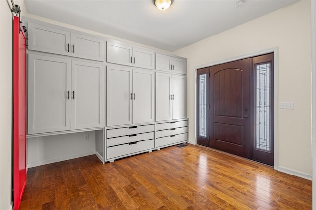 entrance foyer featuring dark wood-type flooring and a barn door