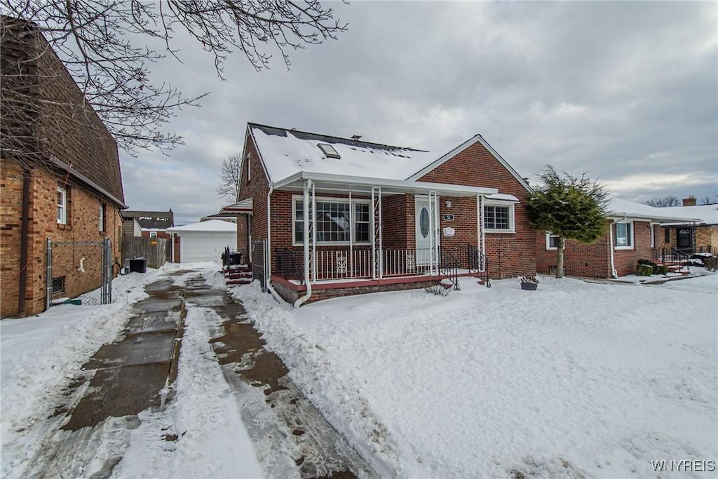 bungalow with a garage and an outbuilding