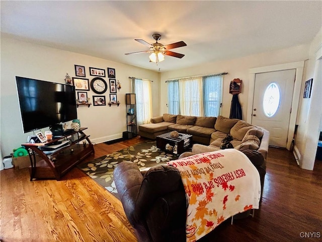 living room featuring ceiling fan and hardwood / wood-style floors