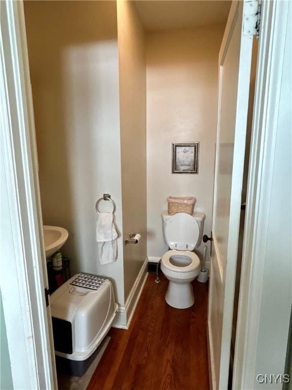 bathroom with toilet and wood-type flooring