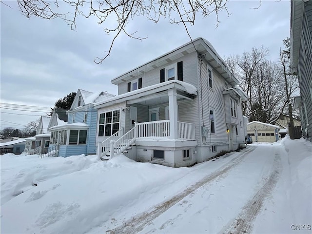 view of front of home with an outbuilding, a porch, and a garage