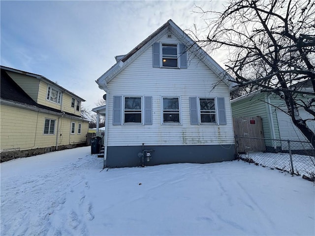 view of snow covered back of property