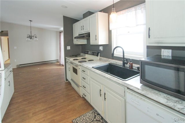 kitchen featuring a baseboard heating unit, sink, pendant lighting, and white appliances