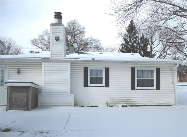 view of snow covered rear of property