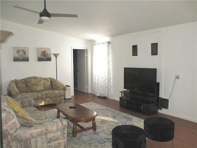 living room featuring ceiling fan, dark wood-type flooring, and lofted ceiling