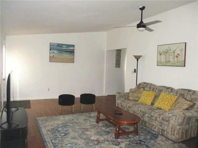 living room with ceiling fan, wood-type flooring, and vaulted ceiling