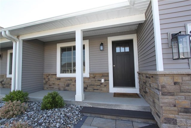 view of exterior entry featuring a porch