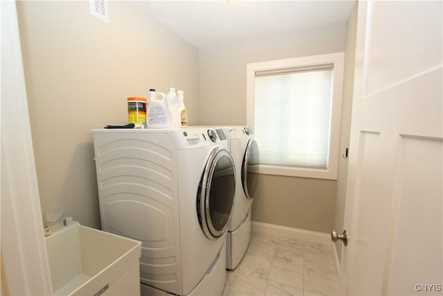 clothes washing area with sink and independent washer and dryer