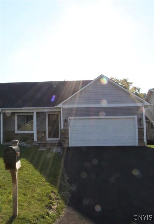 single story home with a front yard and a garage