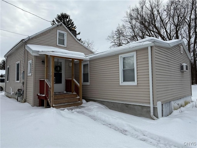 view of front of property with a wall mounted AC