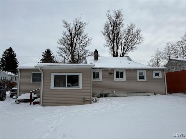 view of snow covered rear of property