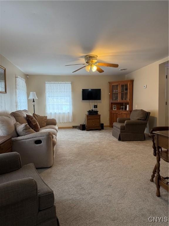 living room with light carpet and ceiling fan