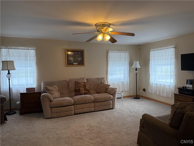 living room with light carpet, ceiling fan, and a baseboard radiator