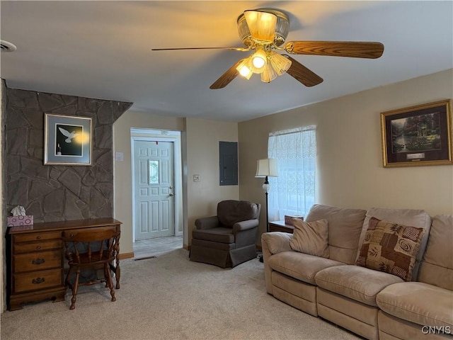 carpeted living room with ceiling fan and electric panel