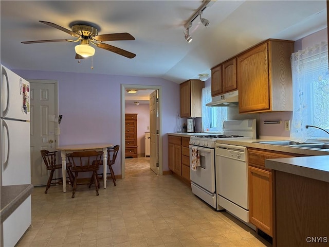 kitchen featuring vaulted ceiling, ceiling fan, sink, and white appliances