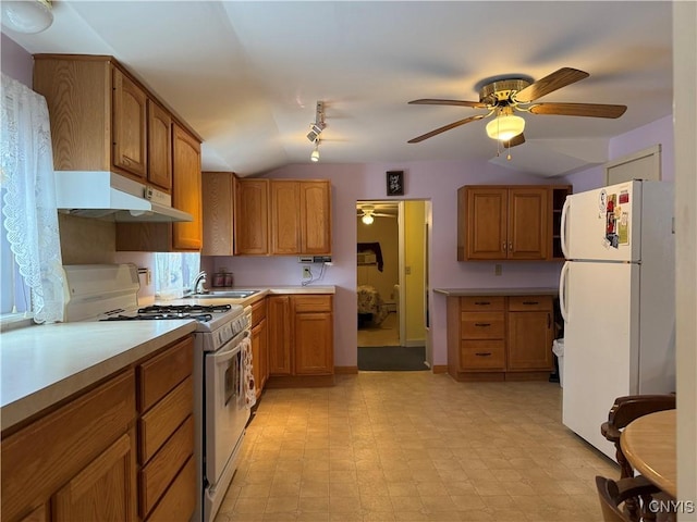 kitchen featuring lofted ceiling, ceiling fan, sink, and white appliances