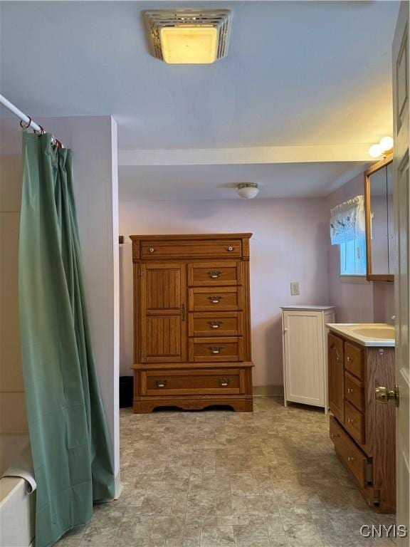 bathroom with vanity and shower / bathtub combination with curtain