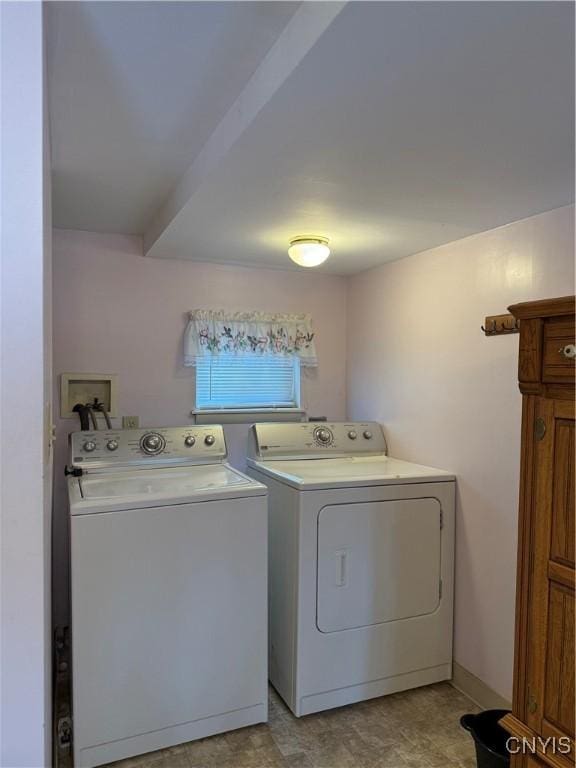 clothes washing area with cabinets and washing machine and clothes dryer