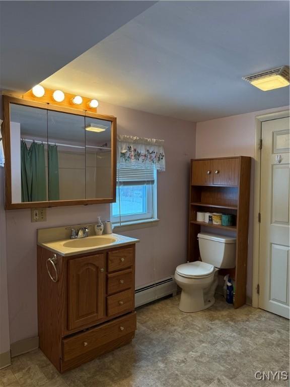 bathroom featuring toilet, baseboard heating, a shower with shower curtain, and vanity