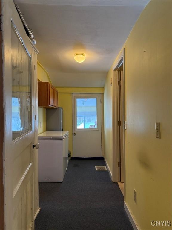 interior space featuring dark colored carpet