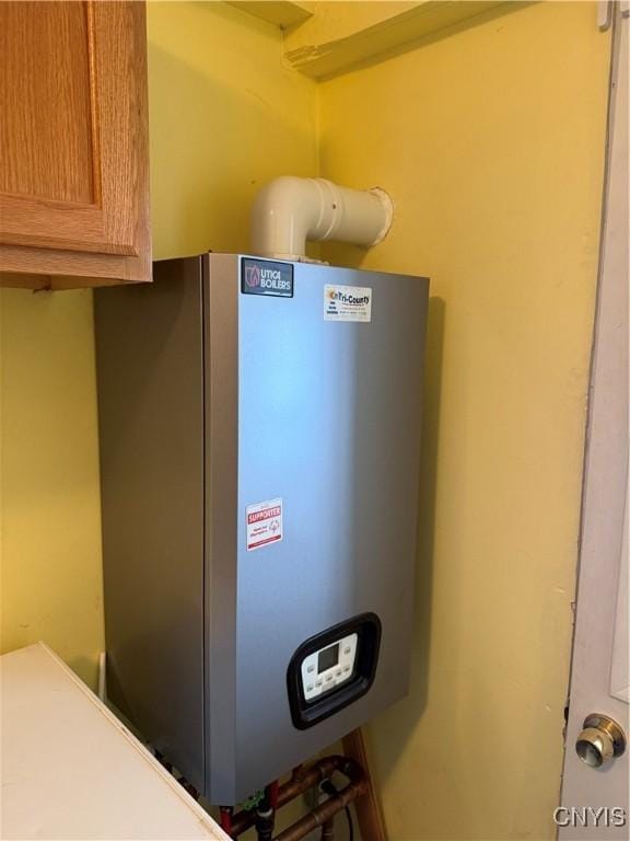 utility room featuring water heater