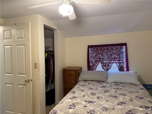 bedroom featuring ceiling fan, a closet, and lofted ceiling