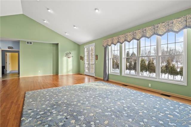 empty room featuring lofted ceiling and hardwood / wood-style floors