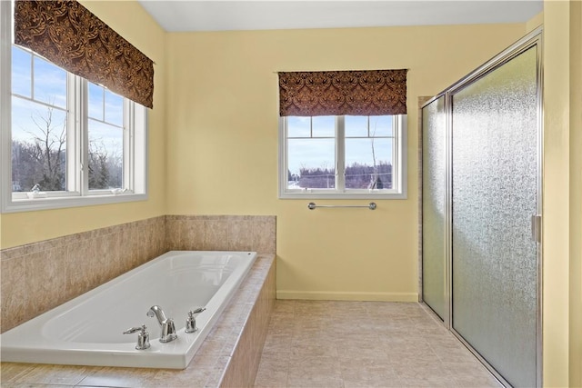 bathroom featuring independent shower and bath