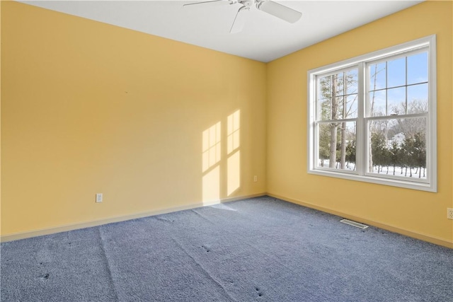 empty room featuring ceiling fan and carpet floors