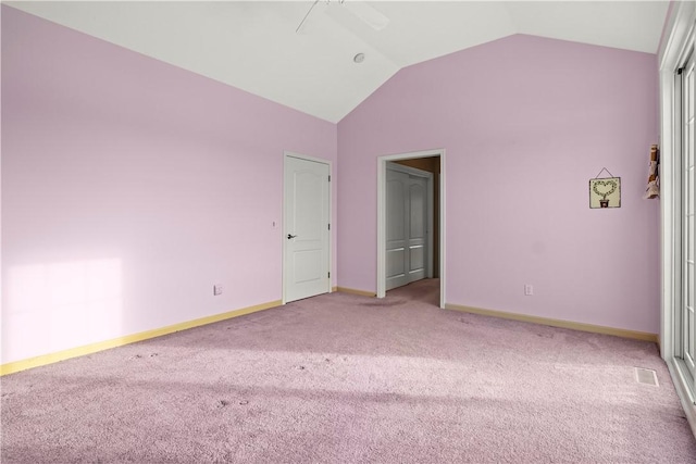 unfurnished bedroom with ceiling fan, a closet, carpet flooring, and lofted ceiling