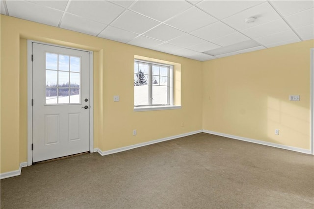 interior space with carpet floors and a paneled ceiling