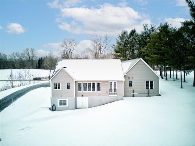 view of snow covered rear of property