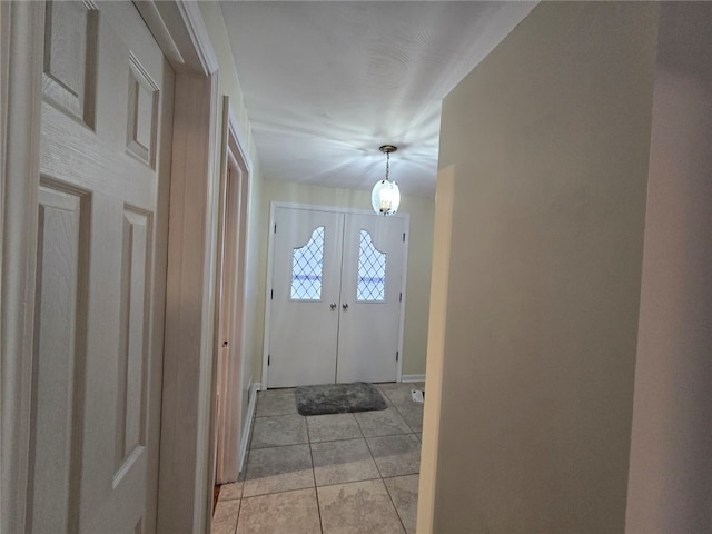 entrance foyer featuring french doors and light tile patterned flooring