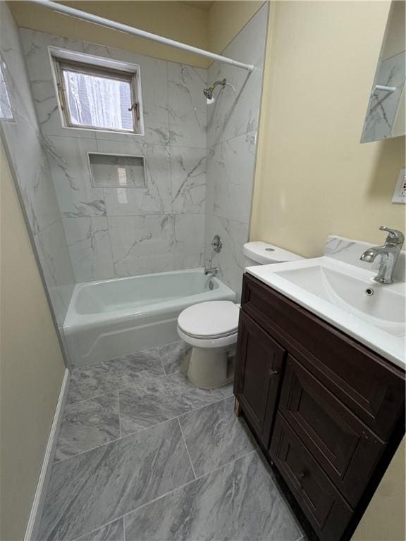 full bathroom with vanity, tiled shower / bath combo, and toilet