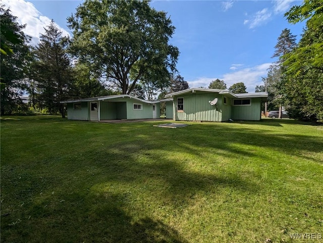 rear view of house with a yard