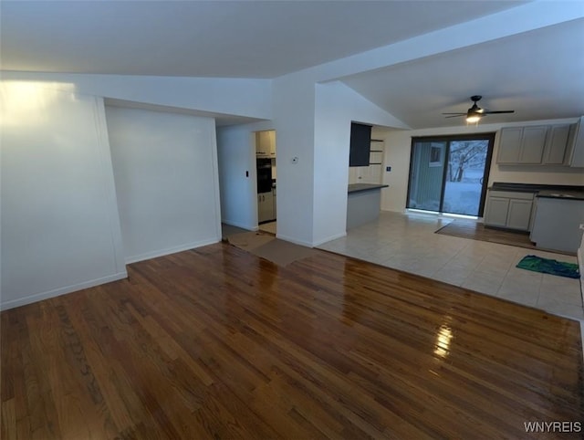 unfurnished living room featuring vaulted ceiling, ceiling fan, and hardwood / wood-style floors